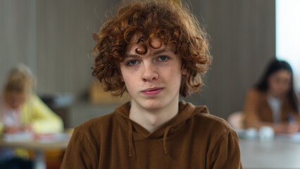 High school university teenager education study calm smiling peaceful serious Caucasian guy boy pupil teen male man schoolboy student studying learning college looking at camera class lesson portrait