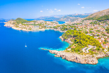 A breathtaking view of the Dubrovnik coastline, showcasing the Adriatic Sea, rugged cliffs, and lush Mediterranean landscape, with untouched nature and warm sunlight enhancing this Dalmatian gem.