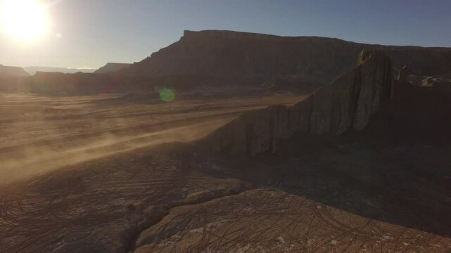 Desert dust blowing in the air over beautiful southern Utah environment at sunset - high, drone shot