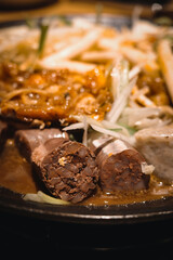 A serving of braised blood sausage with rich sauce flavor