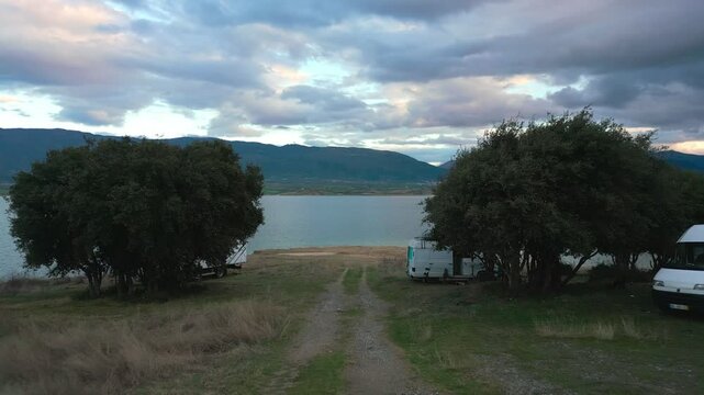 Camper vans parked on a wild spot in Lake Polyfyto, Greece