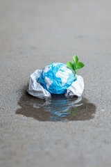 Environmental action crumpled earth in water nature photography urban environment close-up perspective sustainability concept