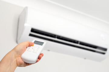 Concept of turning on or off ac or air conditioner by remote control.