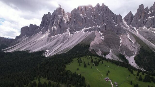 DRONE AERIAL FOOTAGE - The Odle Group is an impressive mountain range in the Dolomites, Bolzano, Trentino Alto Adige, Italy. The main peak of this massif is Mt. Sass Rigais.