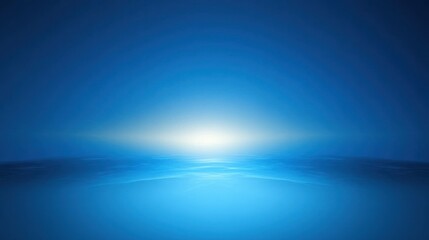 Sunrise over calm ocean with gradient blue sky and horizon glow