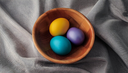 easter festive vivid eggs in a wood bowl on a heritage of gray cotton material