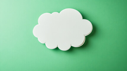 White paper cutout thought bubble on fresh green background offers minimalist design appeal