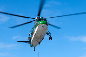Fototapeta premium flying helicopter in the blue sky
