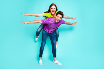 Full length body size view of nice attractive playful funny cheerful cheery couple guy carrying...