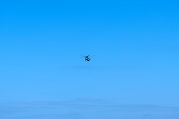 flying helicopter in the blue sky