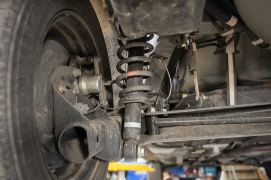 Shock spring under a car tire. 