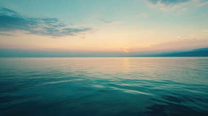 Obraz premium A serene boat floats on calm waters during a breathtaking sunset, casting vibrant reflections and creating a peaceful atmosphere.