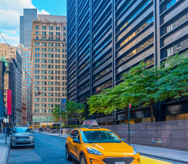 Naklejka premium Taxi passing by in Lower Manhattan