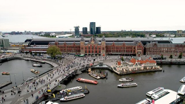Beautiful aerial cinematic footage of the Amsterdam Centraal Train Station  A historic hub with canals, bikes, cafes, and stunning city views all around Amsterdam