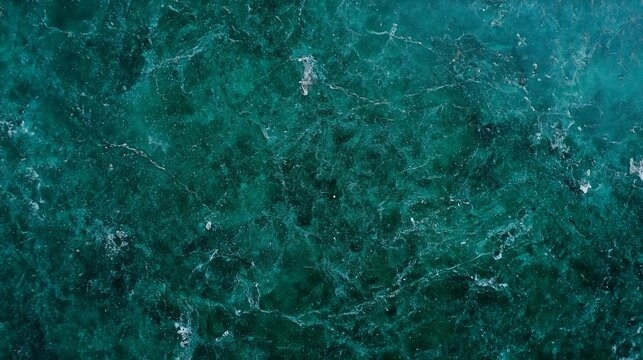Close-up view of a polished emerald green marble surface background, showcasing elegant veins and a luxurious texture, great for product photography