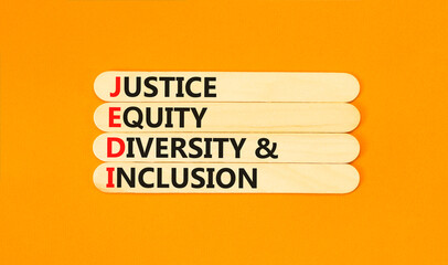Justice equity diversity inclusion symbol. Concept words JEDI Justice Equity Diversity Inclusion on sticks. Beautiful orange background. Business justice equity diversity inclusion concept. Copy space