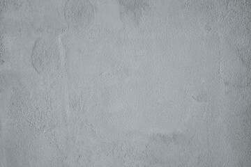 A close-up of a textured concrete surface with subtle patterns and natural imperfections. The rough and raw industrial feel makes it suitable for backgrounds, architecture themes, design templates, an