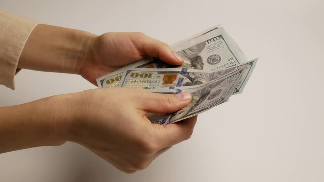 Girl counts cash, representing profit, financial freedom, and business success. A symbol of wealth and economic stability