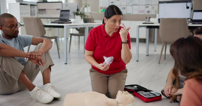 First aid, training and mannequin with people in workshop for learning, healthcare and demonstration. Paramedic course, instructor and teaching with person in class for emergency, rescue and cpr