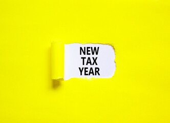 New tax year symbol. Concept words New tax year on beautiful white paper. Beautiful yellow table yellow background. Business new tax year concept. Copy space.