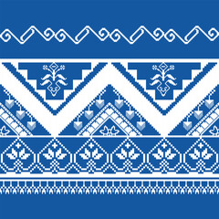 Traditional Ukrainian cross-stitch pattern with pixelated floral motifs. This pattern is white on a blue background with geometric shapes and flowers. Ukrainian embroidery with geometric patterns.