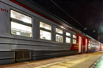 Obraz premium Suburban train with open doors on the platform in the evening. Dmitrov, Moscow region, Russia