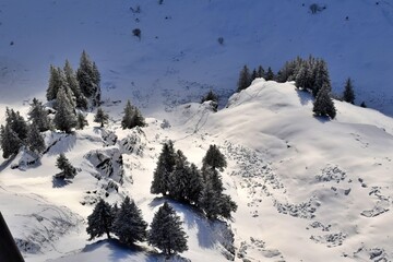 Panorama of snow covered mountains with blue sky and clouds. Winter season landscape and ski slopes. 