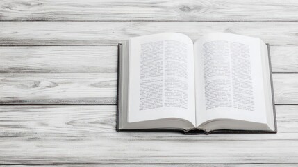 Obraz premium Open Book On White Wooden Table