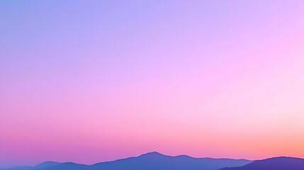 Obraz premium Pastel Sunset Over Silhouetted Mountains