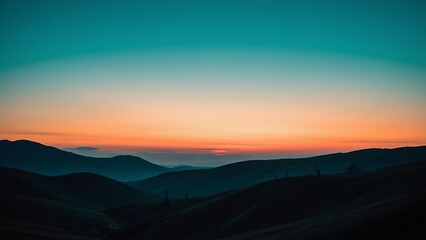 Fototapeta premium Mountains silhouetted against a gradient sky