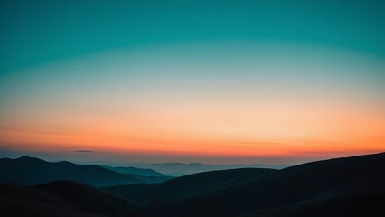 Fototapeta premium Mountains silhouetted against a gradient sky