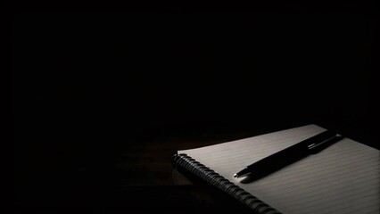 Sketching Creativity Blank Notebook and Pen Resting in Dim Light Artistic Workspace Setting Minimalist Environment Close-up Perspective Inspiration for Writers