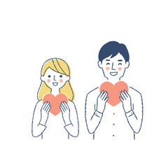 ハートを持っている笑顔の若いカップル