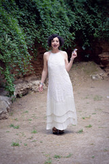 Jazz singer, dressed in a white 1920s party dress singing and dancing.