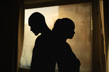 silhouette of a young couple upset,  having disagreement, relationship problem, misunderstanding 