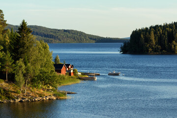 Small wooden summer houses by the lakeside in the north of Sweden