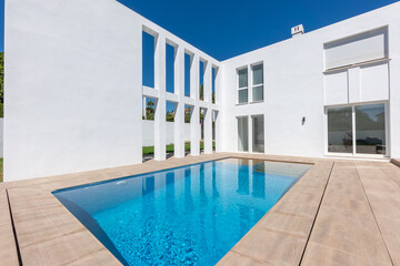 Fototapeta premium a close up image of a luxury outdoor swimming pool in the garden of a mediterranean villa for sale 