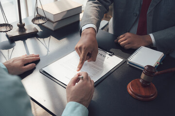 Legal Consultation:  A lawyer guides a client through an important document, emphasizing key...
