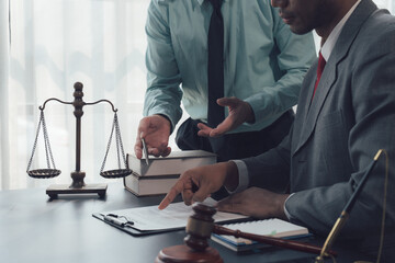 Legal Counsel:  Two professional lawyers discuss legal documents,  with a scale of justice and...