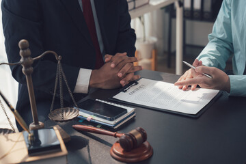Legal Consultation: A lawyer and client engage in a serious discussion, emphasizing the importance...