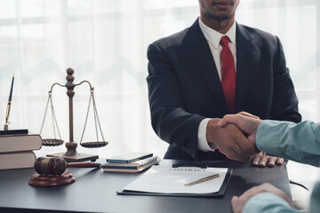 Legal Counsel and Client Handshake: A lawyer in a crisp suit and red tie extends his hand for a...