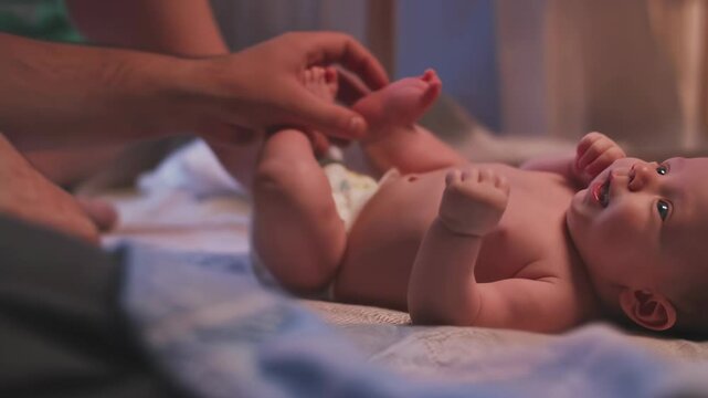Adorable baby lying on back and playing with parent