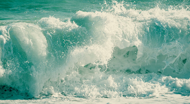 The waves hit the sand in the beach in close-up