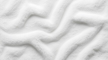 Textured surface of white sand with soft curves and patterns created by wind or movement