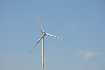 Top of a sunny wind turbine on a clear blue sky 