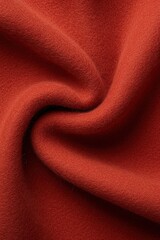 Textured wool fabric in vibrant rust color showcasing intricate weave