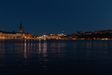 Fototapeta premium Cityscape at night at the harbor in the capital of Sweden - Stockholm