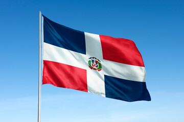 Waving Dominican Republic flag, national symbol, blue sky
