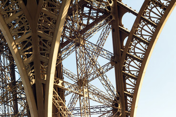 Metal frame of the Eiffel Tower in Paris in bright daylight