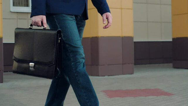 Businessman holds briefcase willing to attend significant event. Businessman carries briefcase concentrating on upcoming meeting. Busy man walks with briefcase containing necessary materials for event